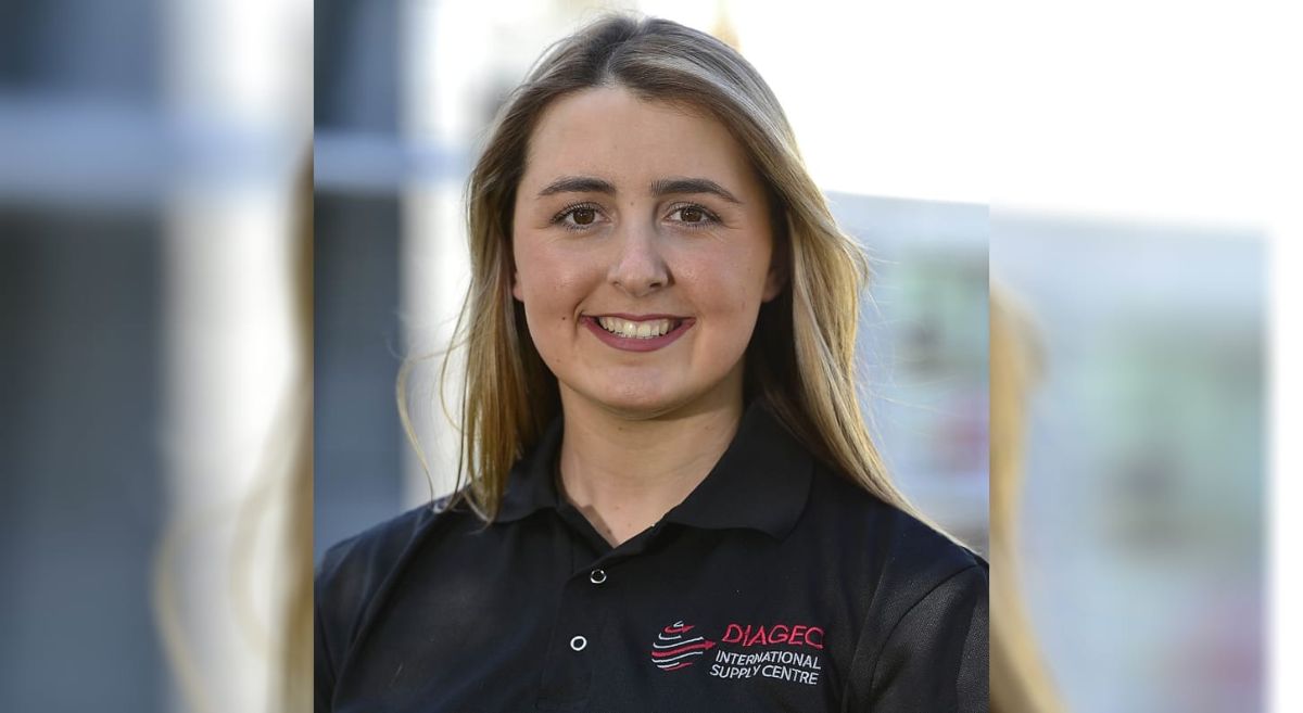 Lauren Johnston - young woman smiling to camera  wearing black top with Diageo branding.